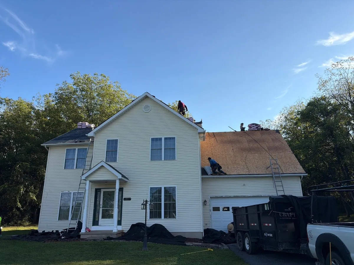 Two-story farmhouse-style home at the start of the roof replacement in Arden, Inwood, WV