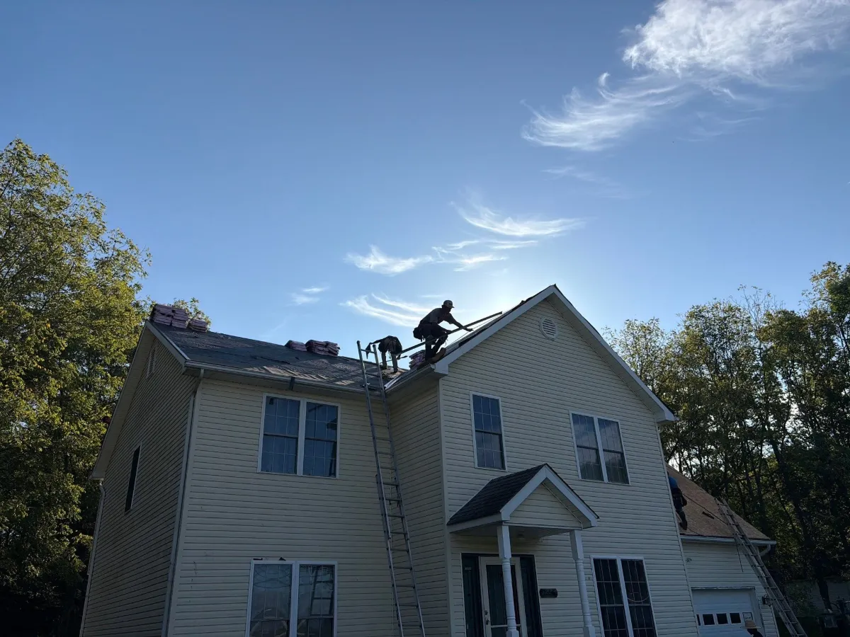 Crew working on the upper roof during tear-off in Arden, Inwood, WV