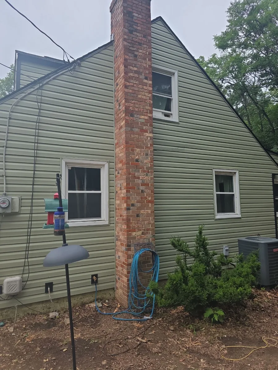 New siding beside the brick chimney in Harpers Ferry, WV