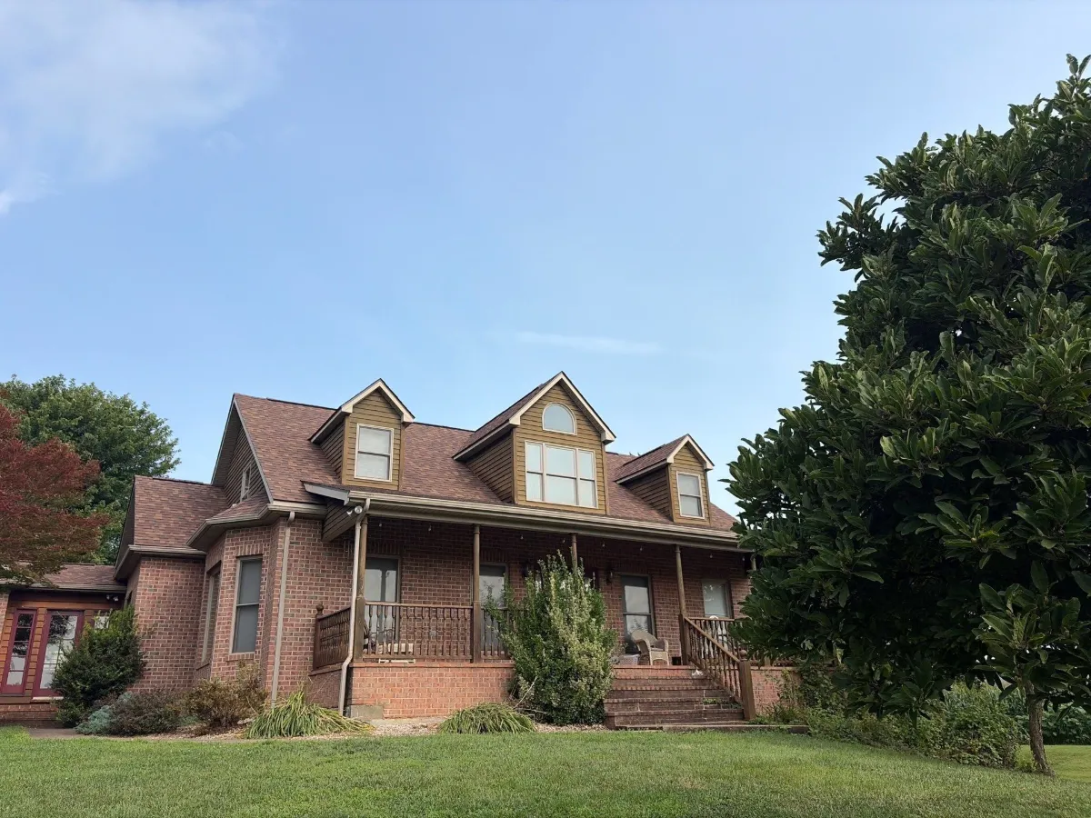 Side of the brick home with the new roof in Martinsburg, WV