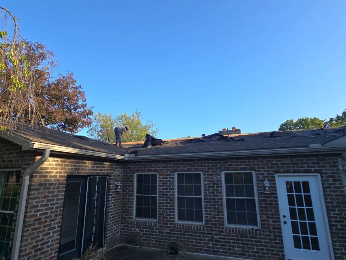 Side of the stone ranch home with its original roof in Martinsburg, WV