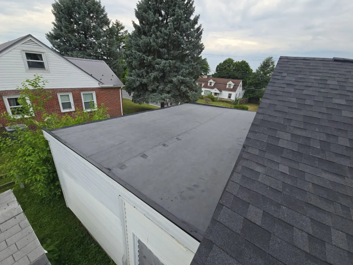 Low-slope roof section and garage after the replacement in Waynesboro, PA